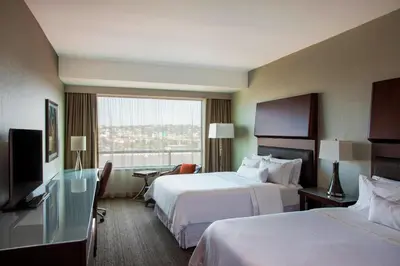 a hotel room with two beds and a large window at The Westin Wilmington in Wilmington