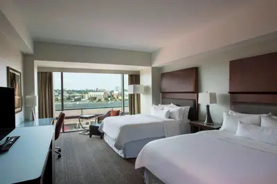 a hotel room with two beds and a large window at The Westin Wilmington in Wilmington