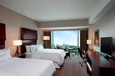 a hotel room with two beds and a flat screen tv at The Westin Wilmington in Wilmington