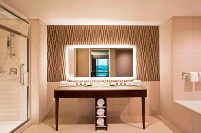 a bathroom with a sink and a shower and a mirror at The Westin Wilmington in Wilmington
