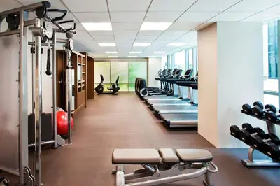 a gym with a row of treadmills and machines at The Westin Wilmington in Wilmington