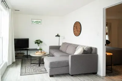 a living room with a couch and a tv at The Carriage House at Strasburg in Strasburg