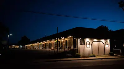 a building with lights on the side of it at night at The Carriage House at Strasburg in Strasburg