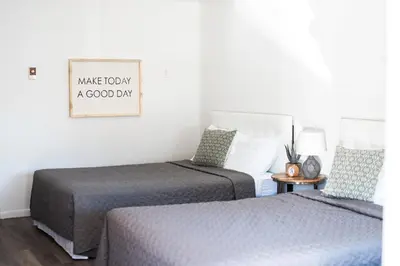 a bedroom with two beds and a sign that says make today a good day at The Carriage House at Strasburg in Strasburg