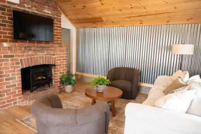 a living room with a couch and a fireplace at The Carriage House at Strasburg in Strasburg