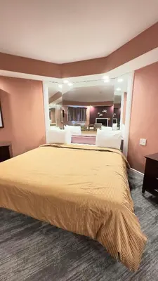 a hotel room with a large bed in a room at Inn of the Dove Harrisburg-Hershey Romantic Suites in Harrisburg