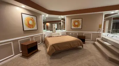 a bedroom with a bed and a bath room at Inn of the Dove Harrisburg-Hershey Romantic Suites in Harrisburg