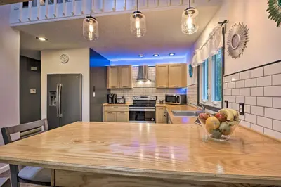a kitchen with a table with a bowl of fruit on it at 7 Mi to Tobyhanna State Park Quiet Retreat! in Tobyhanna
