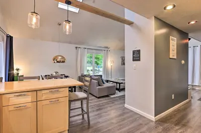a kitchen and living room with a table and a couch at 7 Mi to Tobyhanna State Park Quiet Retreat! in Tobyhanna