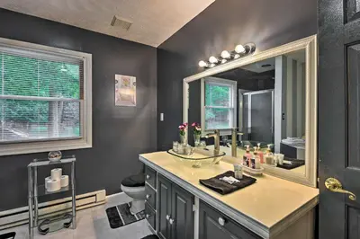 a bathroom with a sink and a mirror at 7 Mi to Tobyhanna State Park Quiet Retreat! in Tobyhanna