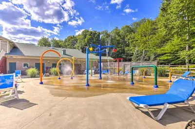 a playground with a blue chair and slides at Wraparound Deck Big Bass Lake Home in Gouldsboro in Gouldsboro