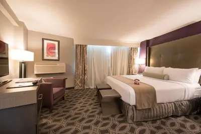 a hotel room with a large bed and a desk at Crowne Plaza Saddle Brook by IHG in Saddle Brook