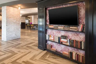 a television on a wall with books at Crowne Plaza Saddle Brook by IHG in Saddle Brook