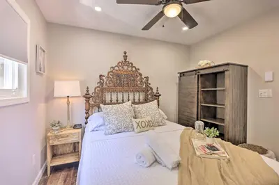 a bedroom with a large bed with a wooden headboard at Fire Pit and Furnished Deck Serene Tobyhanna Escape in Tobyhanna