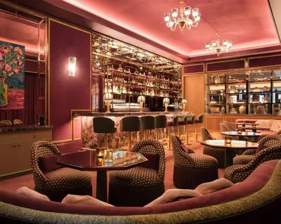 a restaurant with tables and chairs and a bar at Fouquet's New York in New York