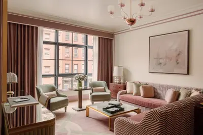 a living room with a couch and chairs at Fouquet's New York in New York