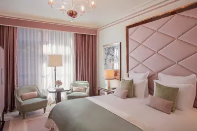 a bedroom with a large bed and two chairs at Fouquet's New York in New York