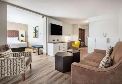 a living room with a couch and a bed at DoubleTree by Hilton Monroe Township Cranbury in Monroe Township