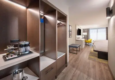 a hotel room with a closet and a bed at DoubleTree by Hilton Monroe Township Cranbury in Monroe Township