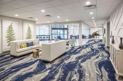 an office with couches and chairs in a lobby at DoubleTree by Hilton Monroe Township Cranbury in Monroe Township