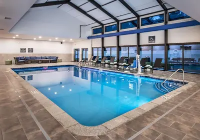 a large pool with blue water in a building at DoubleTree by Hilton Monroe Township Cranbury in Monroe Township