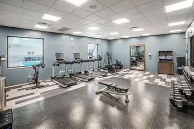 a gym with several treadmills and exercise machines at DoubleTree by Hilton Monroe Township Cranbury in Monroe Township