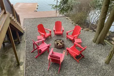 a group of red chairs and a fire pit at Harmony Haven in Lake Harmony