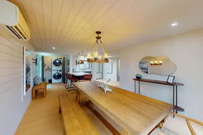 a dining room and living room with a wooden table at Harmony Haven in Lake Harmony