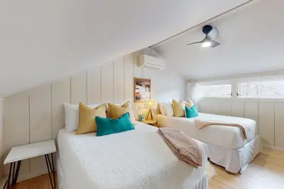 a bedroom with two beds with blue pillows at Harmony Haven in Lake Harmony