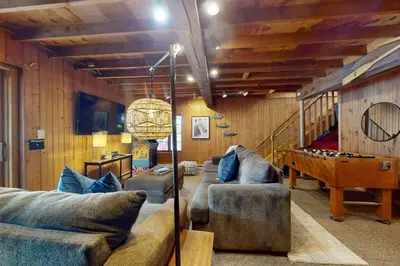 a living room with couches and a pool table at Harmony Haven in Lake Harmony