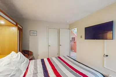 a bedroom with a bed with a tv on the wall at Jumpin' Jack Frost in Lake Harmony
