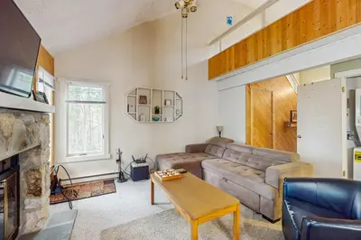 a living room with a couch and a table at Jumpin' Jack Frost in Lake Harmony