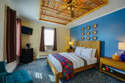 a bedroom with a bed and a ceiling fan at La Posada in Milford