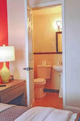 a bathroom with a toilet and a sink at La Posada in Milford