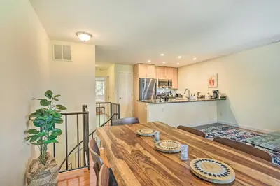 a kitchen and dining room with a wooden table at Sun-Lit Vernon Condo Less Than 2 Mi to Ski Resort! in Vernon Township