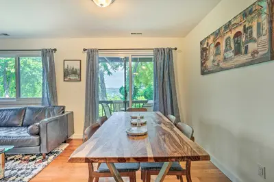 a living room with a wooden table and a couch at Sun-Lit Vernon Condo Less Than 2 Mi to Ski Resort! in Vernon Township