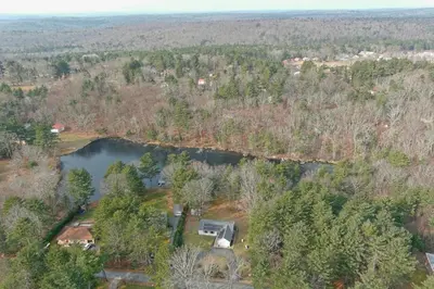 an aerial view of a house and a lake at Spacious Catskills Serenity nearby Delaware River Gap w Game Rm Pet Friendly and Fenced Yard in Glen Spey