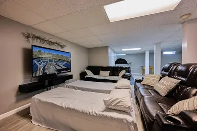 a living room with two beds and a couch at Spacious Catskills Serenity nearby Delaware River Gap w Game Rm Pet Friendly and Fenced Yard in Glen Spey