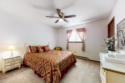 a bedroom with a bed and a ceiling fan at The Burrow in Jim Thorpe