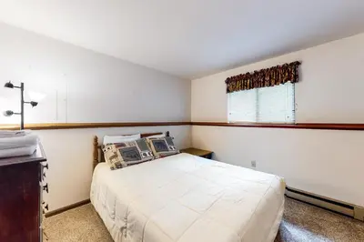 a bedroom with a bed and a window at The Burrow in Jim Thorpe