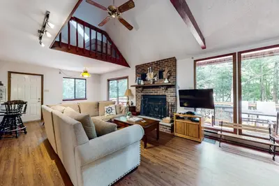 a living room with a couch and a fireplace at The Burrow in Jim Thorpe