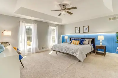 a bedroom with a bed and a ceiling fan at Hot Tub! Family Tobyhanna Getaway 12 Mi to Slopes in Tobyhanna