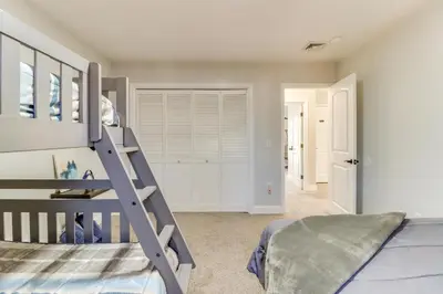 a bedroom with a bunk bed with a ladder at Hot Tub! Family Tobyhanna Getaway 12 Mi to Slopes in Tobyhanna