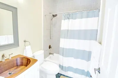 a bathroom with a wooden sink and a toilet at Spacious Oasis - Parking, Private Patio & Roofdeck in Philadelphia
