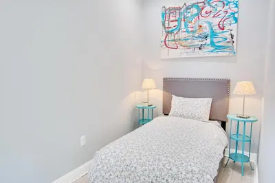 a bedroom with a bed and two lamps at Spacious Oasis - Parking, Private Patio & Roofdeck in Philadelphia