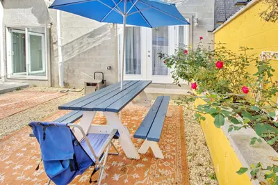 a blue picnic table with a blue umbrella and a chair at Spacious Oasis - Parking, Private Patio & Roofdeck in Philadelphia