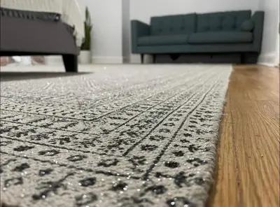 a living room with a rug and a blue couch at A Regal Retreat- Exclusive Parking, Prime Location in Philadelphia