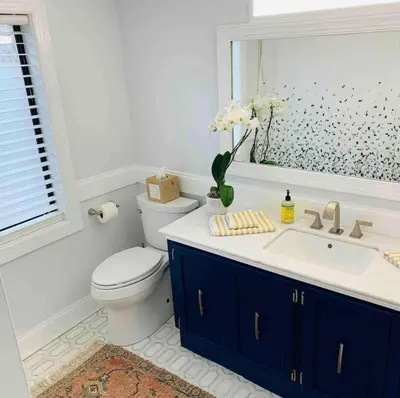 a bathroom with a toilet and a sink and a mirror at A Regal Retreat- Exclusive Parking, Prime Location in Philadelphia