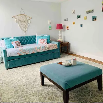a living room with a blue couch and a table at A Regal Retreat- Exclusive Parking, Prime Location in Philadelphia