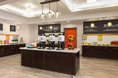 a coffee shop with a counter in a room at Hampton Inn & Suites York South in York